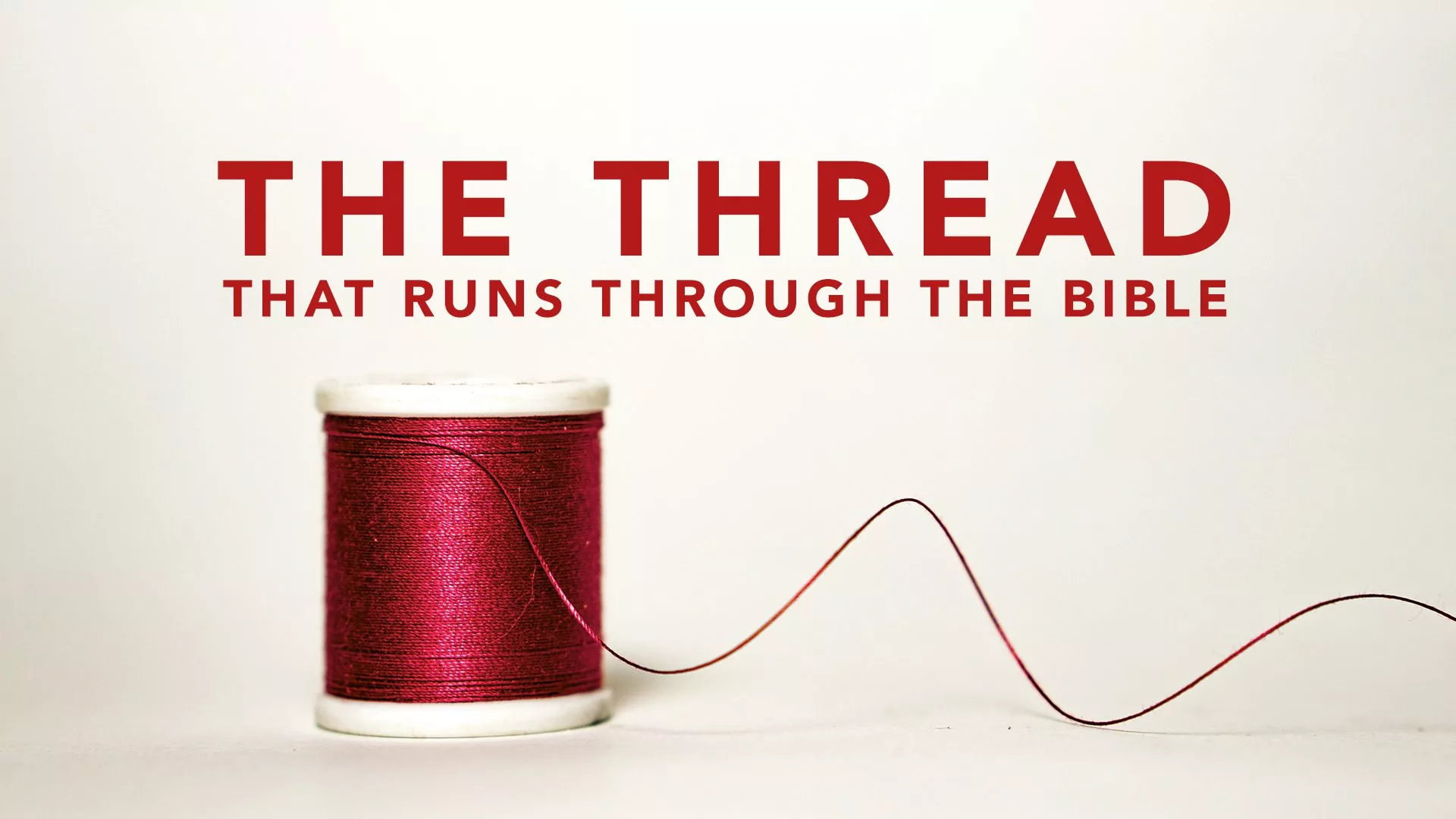 A red spool of thread with the words " the thread that runs through the bible ".